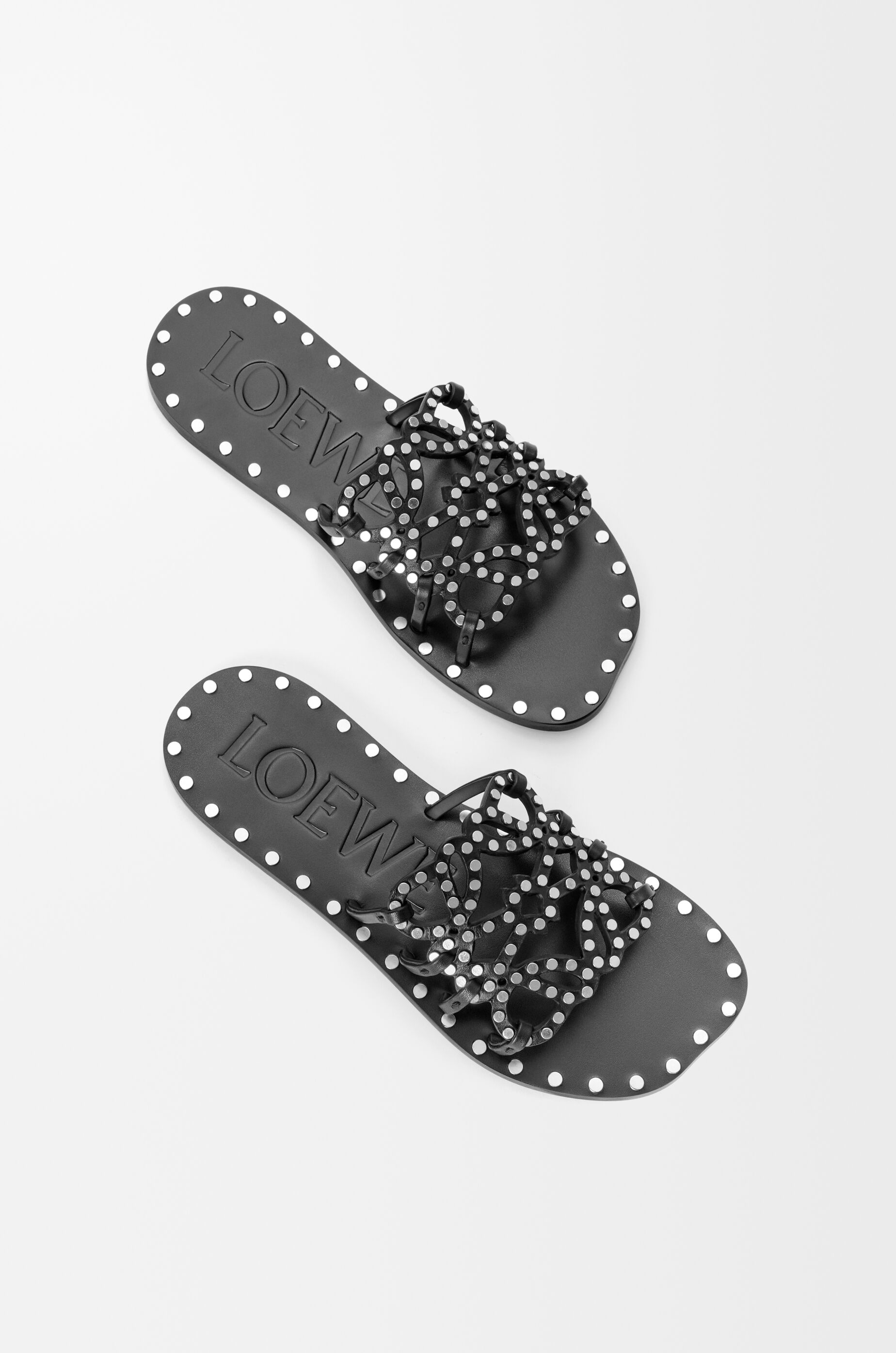 LOEWE Petal Anagram slide in vegetable-tanned calfskin and metallic studs Black